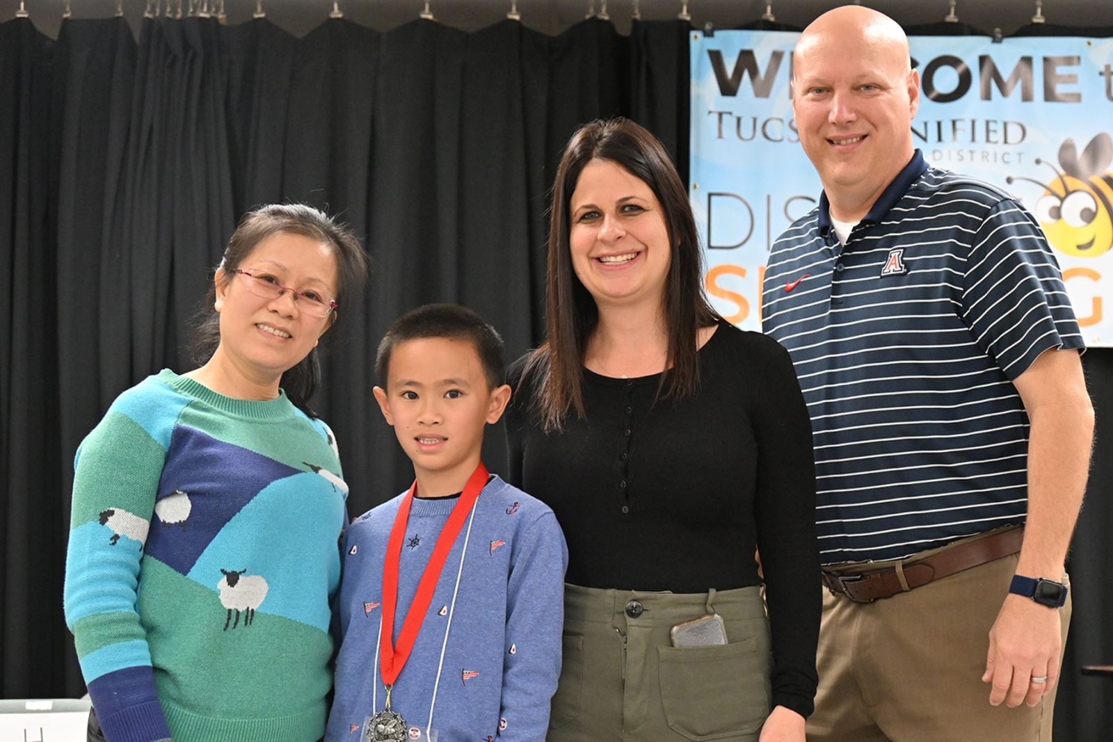 The spelling bee runner-up poses with his family.