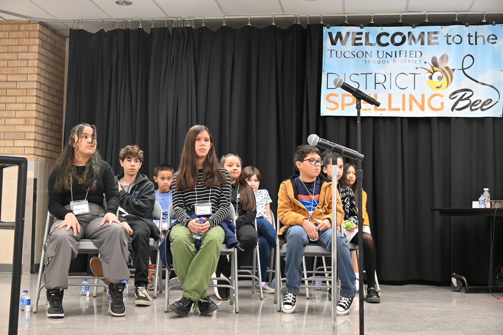 The spelling bee competitors sit waiting for their turn to spell.