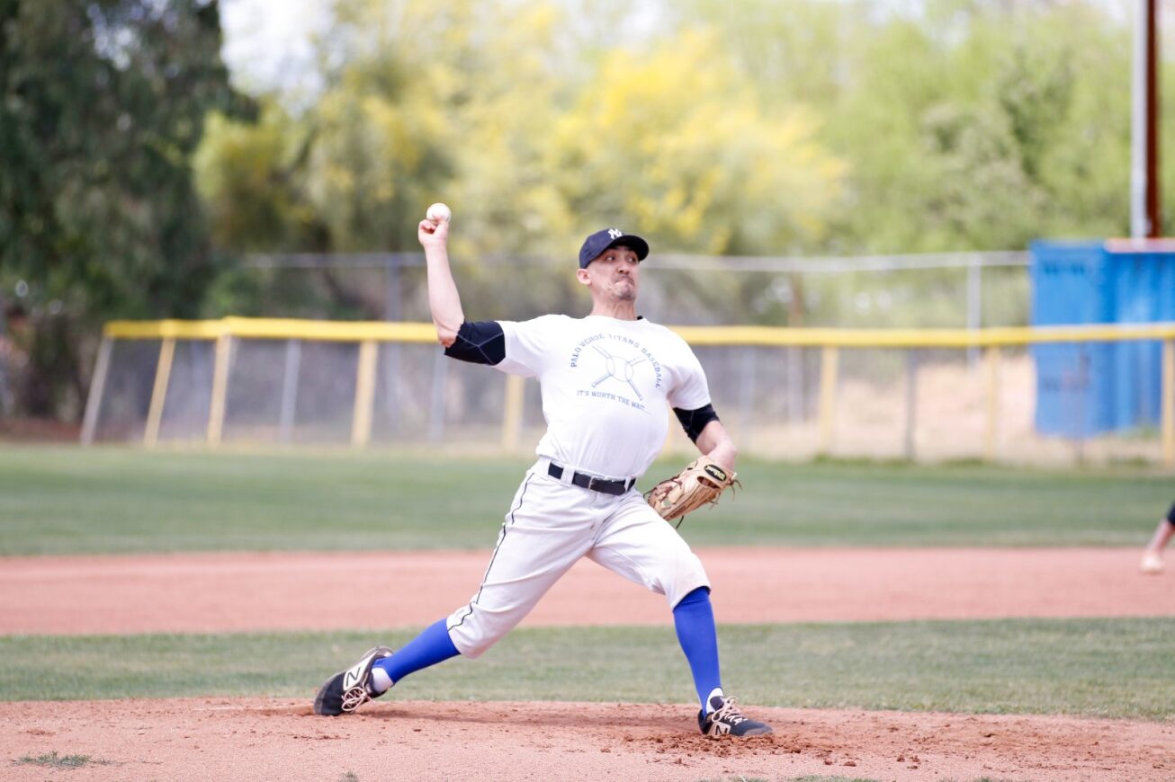 The pitcher winds up to throw the ball