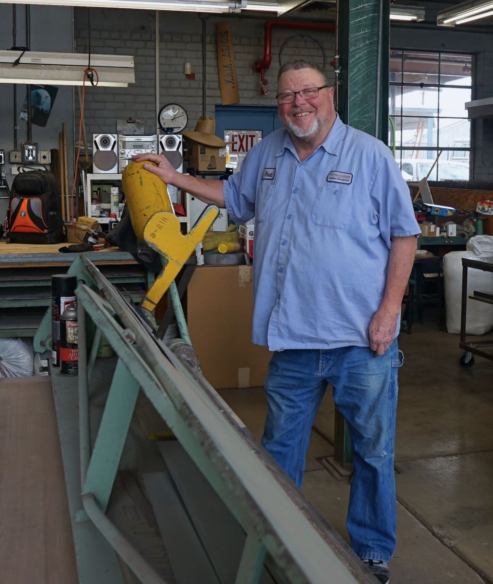 W. Paul Riggleman stands next to the sheet metal equipment he works with daily.