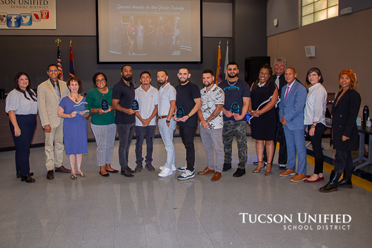 Supporters of Impact Tucson stand with the board members receiving honors.