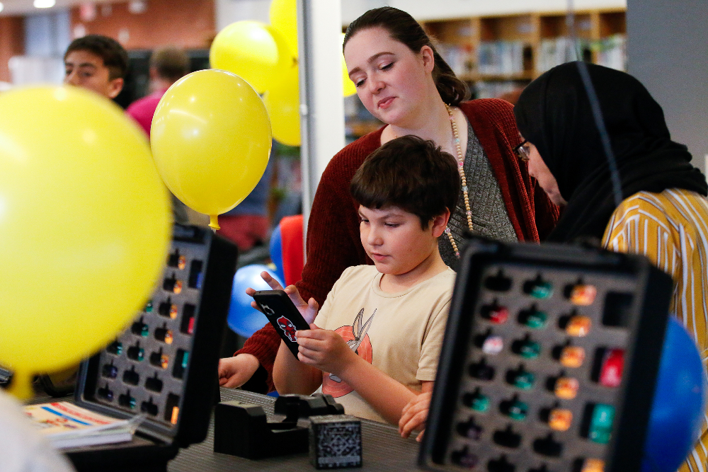 A boy uses a phone to play an educational game