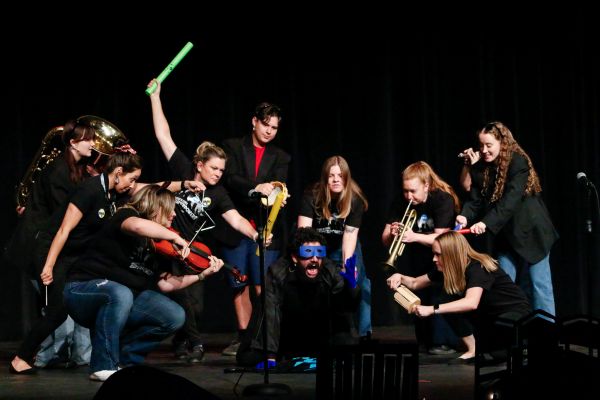 A group of people is superhero poses confront a supervillain