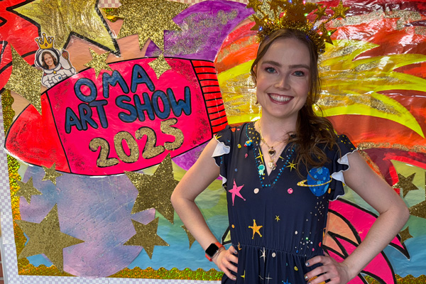 Arts Integration Specialist, Isabel Suhm, wearing a dress made to support her space OMA lessons.