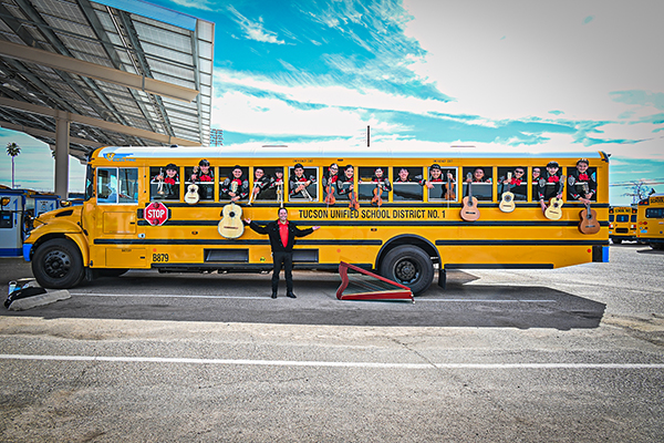 Mariachi musicians pose inside a new EV school bus