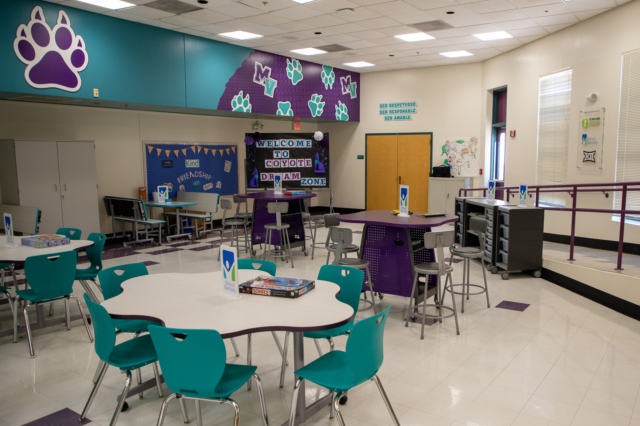 Mission View's improved cafeteria, with tables and chairs set up for students to play games