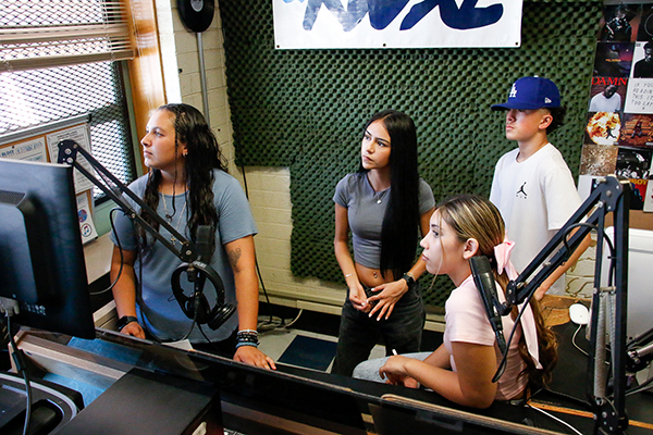 Students in a radio station recording room