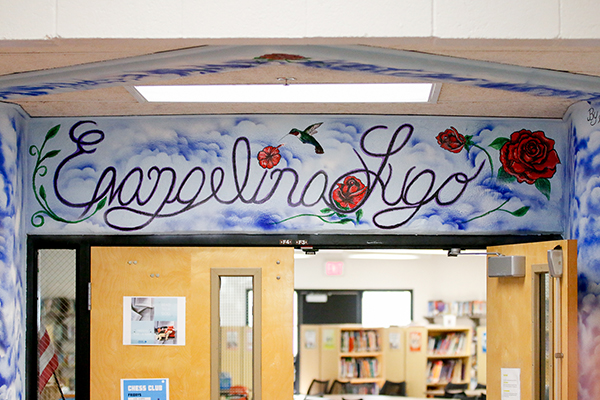 A mural reading Evangelina Lugo painted over the doors of the library