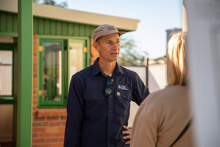 A man talks to a woman in the new Sprouts House space
