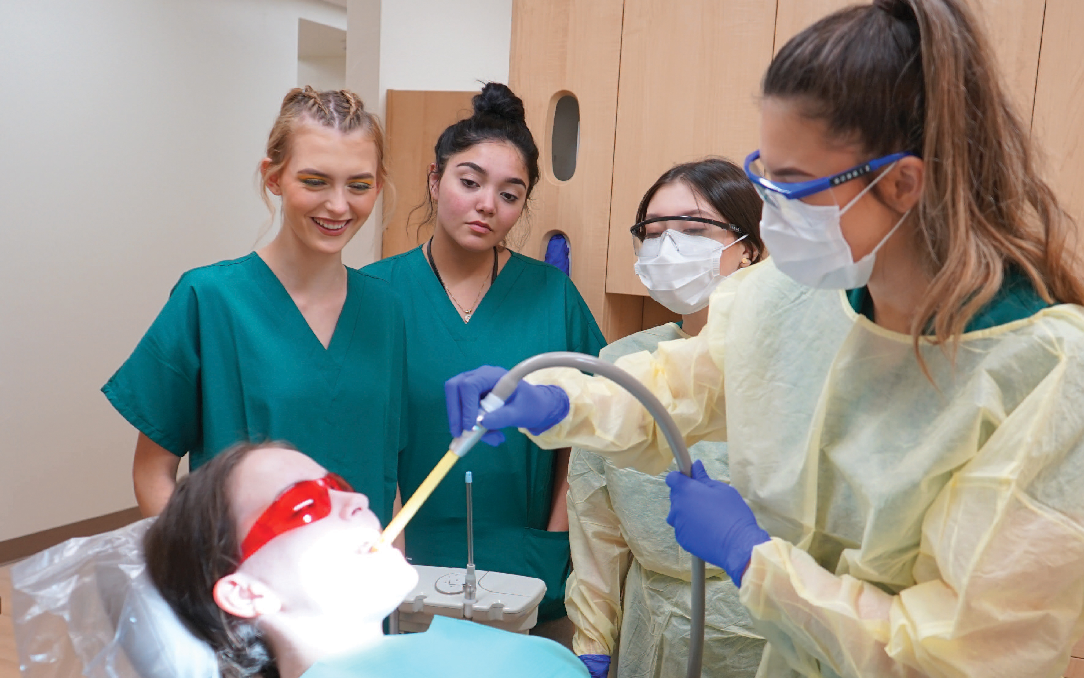 Students perform a dental procedure on a fellow student