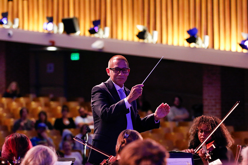 Dr. Trujillo conducts the student musicians during the Superintendent's Concert