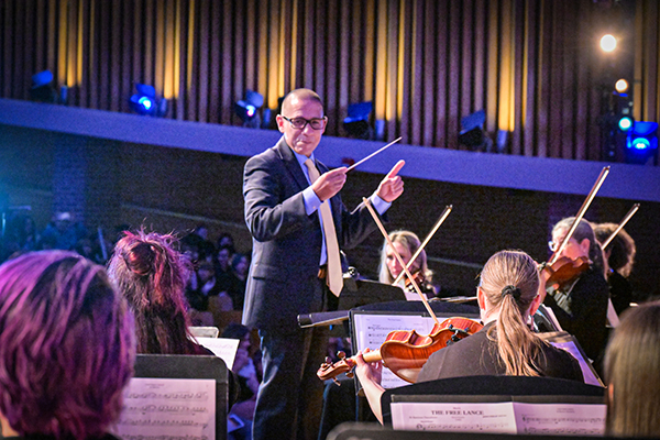 The Superintendent conducts a group of student musicians
